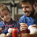 Children's Art Classes Father and son painting a craft.