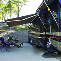 RV with awning and seating.